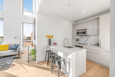 a kitchen with an island and stools